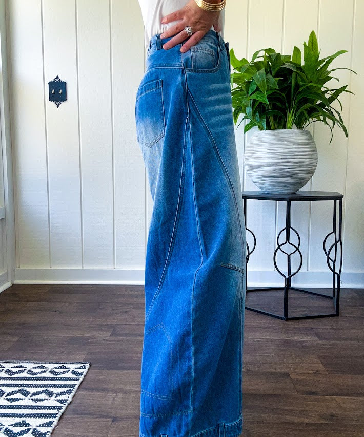 Panel Seam Jeans in Light. Featuring a bold wide-leg silhouette crafted from lightweight light denim, these jeans turn heads with their retro wash and striking contrast stitching and upside-down design at the leg openings.