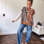 High-rise fit with a curved, architectural leg, rigid denim front, stretch fabric, top block, curved outer seam, and tapered hem that create a modern "barrel" or "horseshoe" shape sitting away from the leg.