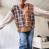 Plaid pullover pairs earth-tone mocha, cream, and rust with playful contrasting stripes on the sleeves with a split neck and relaxed fit.