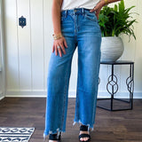 Comfort-stretch denim with a soft, flexible feel
Flattering high-rise fit
Classic five-pocket styling
Unique slant side seam detailing for added dimension
Trendy uneven raw hem finish
Ankle-length wide-leg silhouette
Medium wash denim