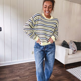 Butter yellow striped knit top with horizontal stripes in dark brown and light blue, a relaxed fit and square hem.