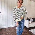 Butter yellow striped knit top with horizontal stripes in dark brown and light blue, a relaxed fit and square hem.