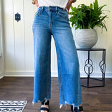 Comfort-stretch denim with a soft, flexible feel
Flattering high-rise fit
Classic five-pocket styling
Unique slant side seam detailing for added dimension
Trendy uneven raw hem finish
Ankle-length wide-leg silhouette
Medium wash denim