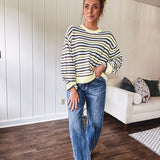 Butter yellow striped knit top with horizontal stripes in dark brown and light blue, a relaxed fit and square hem.