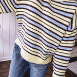 Butter yellow striped knit top with horizontal stripes in dark brown and light blue, a relaxed fit and square hem.