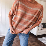 Lightweight, striped drop shoulder sweater tee in a soft sage or rust base  with warm stripes of light brown, taupe, and spice, and ribbed detailing at the neck, cuffs, and hem.
