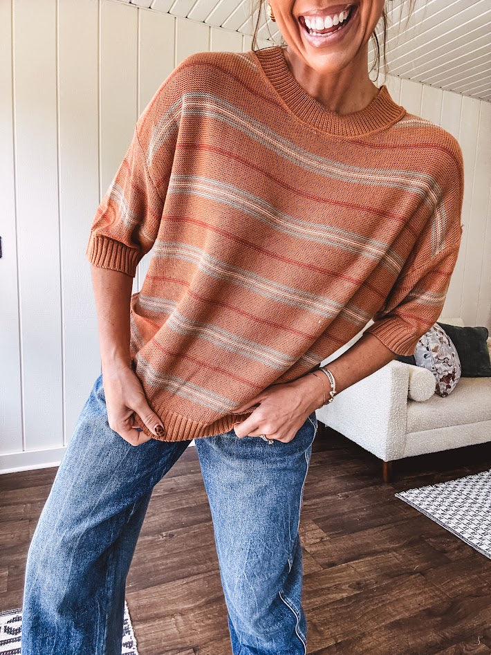 Lightweight, striped drop shoulder sweater tee in a soft sage or rust base  with warm stripes of light brown, taupe, and spice, and ribbed detailing at the neck, cuffs, and hem.