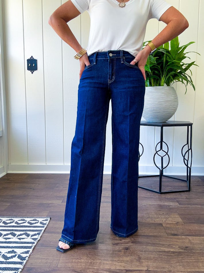 Soft comfort-stretch denim with an easy, flexible fit
Flattering mid-rise waist
Classic five-pocket design
Full-length wide-leg silhouette
Features a trouser-inspired front fold crease detail
Finished hem for a polished look
Dark wash denim