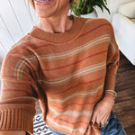 Lightweight, striped drop shoulder sweater tee in a soft sage or rust base  with warm stripes of light brown, taupe, and spice, and ribbed detailing at the neck, cuffs, and hem.