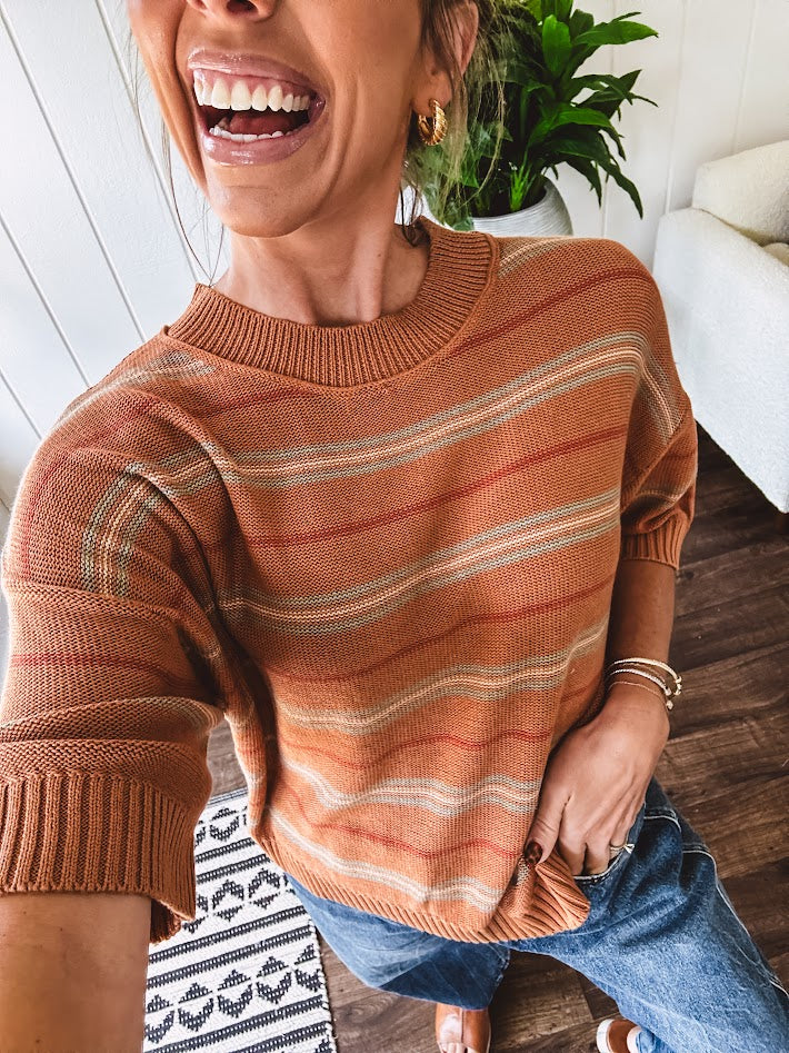 Lightweight, striped drop shoulder sweater tee in a soft sage or rust base  with warm stripes of light brown, taupe, and spice, and ribbed detailing at the neck, cuffs, and hem.