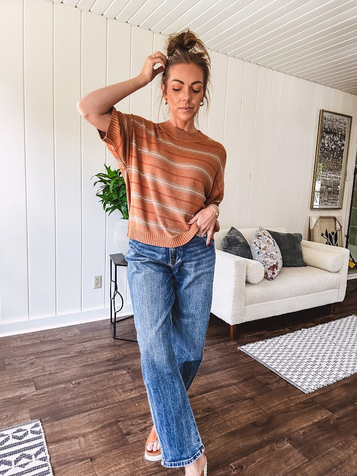 Lightweight, striped drop shoulder sweater tee in a soft sage or rust base  with warm stripes of light brown, taupe, and spice, and ribbed detailing at the neck, cuffs, and hem.