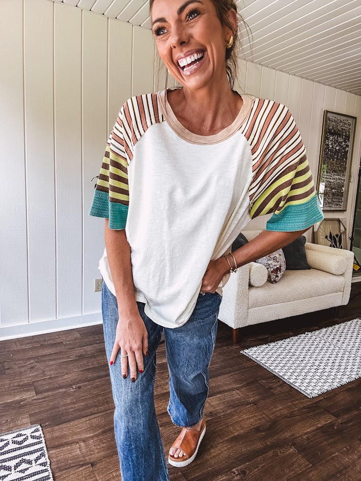 Stripe Mix Cotton Half Sleeve Top. Vibrant striping down the sleeves, exposed seams and a contrasting front and back color blocking, oversized fit and athleisure vibe.