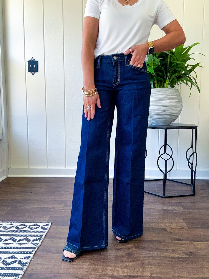 Soft comfort-stretch denim with an easy, flexible fit
Flattering mid-rise waist
Classic five-pocket design
Full-length wide-leg silhouette
Features a trouser-inspired front fold crease detail
Finished hem for a polished look
Dark wash denim