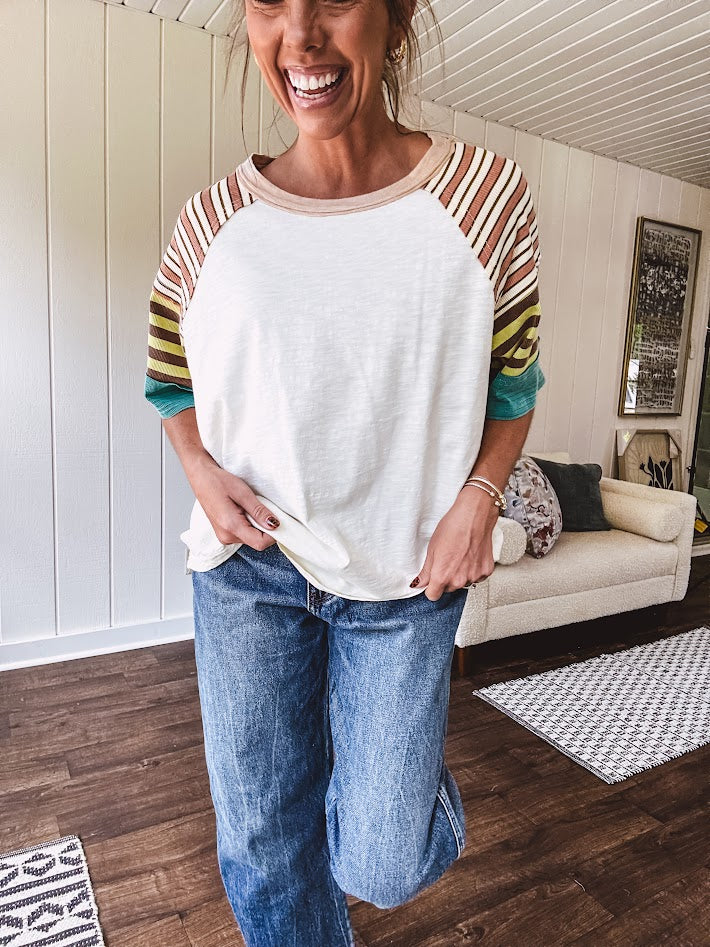 Stripe Mix Cotton Half Sleeve Top. Vibrant striping down the sleeves, exposed seams and a contrasting front and back color blocking, oversized fit and athleisure vibe.