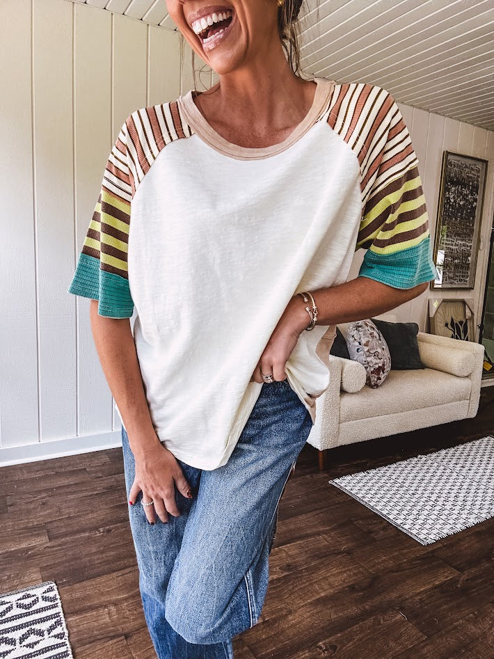 Stripe Mix Cotton Half Sleeve Top. Vibrant striping down the sleeves, exposed seams and a contrasting front and back color blocking, oversized fit and athleisure vibe.