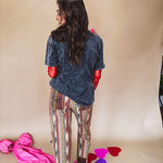 Cotton straight leg ethnic print pants in muted magenta, cream, red, blue and mustard.