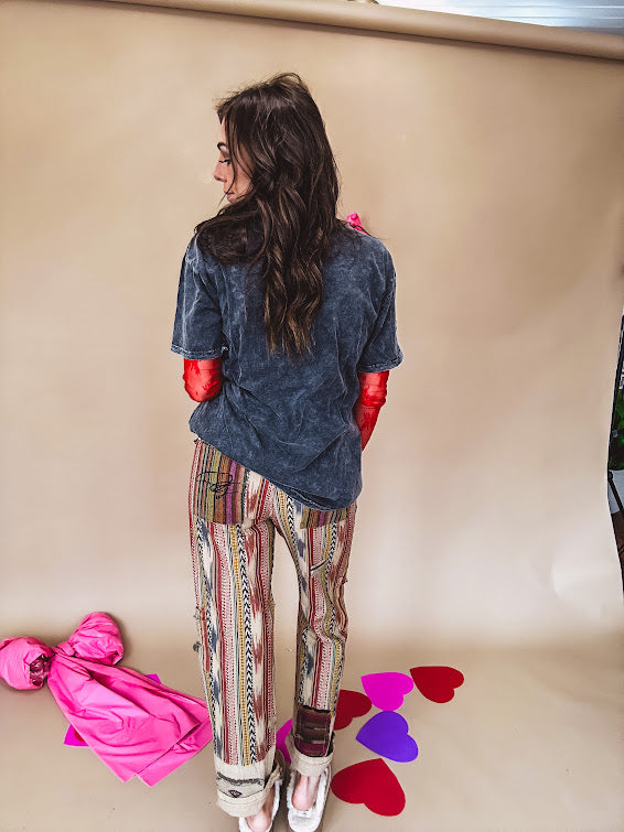 Cotton straight leg ethnic print pants in muted magenta, cream, red, blue and mustard.
