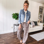 Medium wash non-stretch denim jacket with classic trim, raw, uneven hem and cuffs with silver hardware and cropped length.