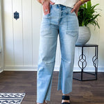 Light wash barrel jeans with extra large pockets and flared, raw hems.