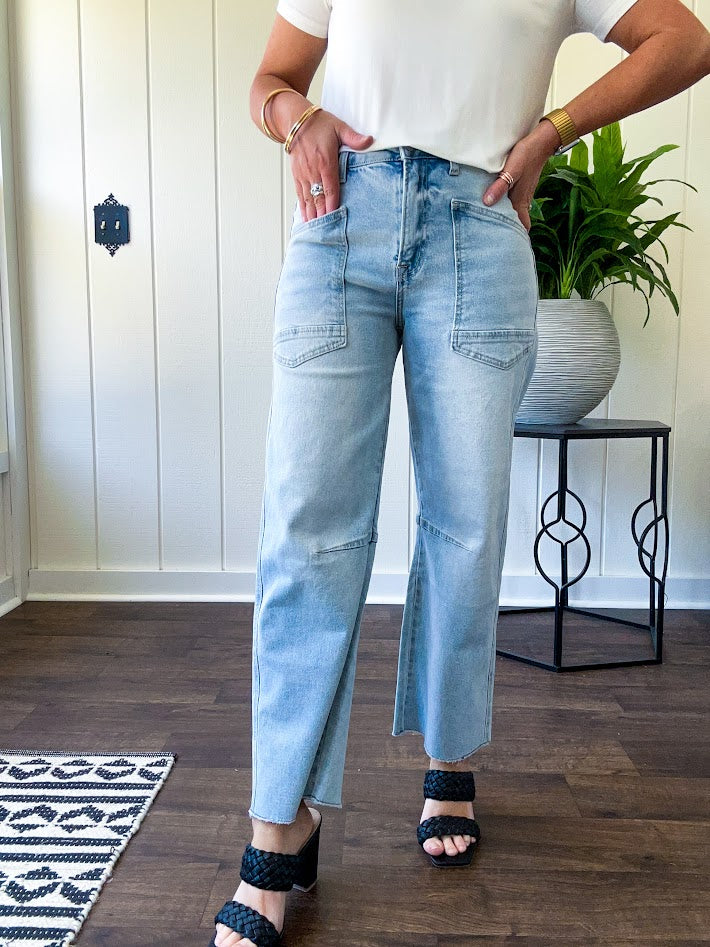 Light wash barrel jeans with extra large pockets and flared, raw hems.