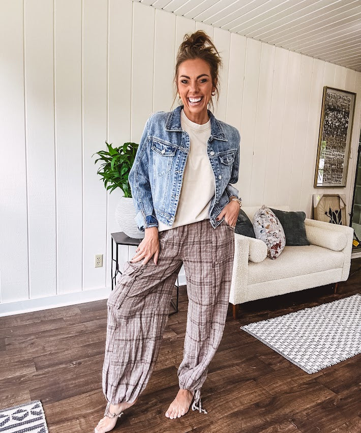 Cotton light mocha plaid mineral wash pants with elastic waist, cargo pockets and drawstring hem.