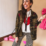 Dark green, olive and black camo jacket with button up front and red western inspired embroidery throughout.