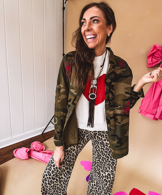 Dark green, olive and black camo jacket with button up front and red western inspired embroidery throughout.