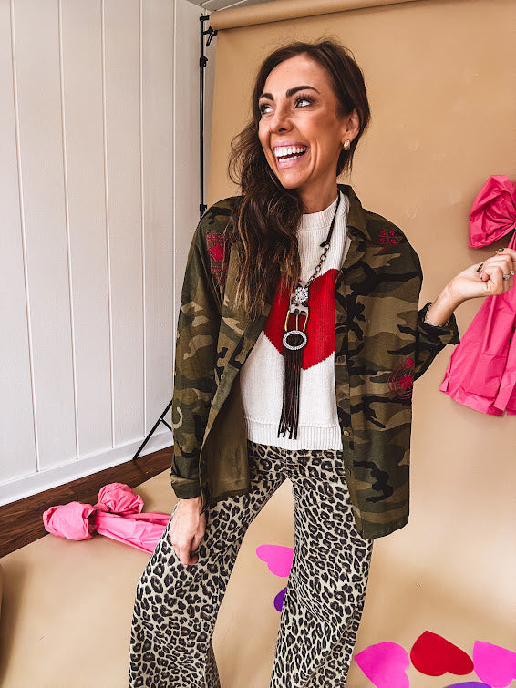 Dark green, olive and black camo jacket with button up front and red western inspired embroidery throughout.