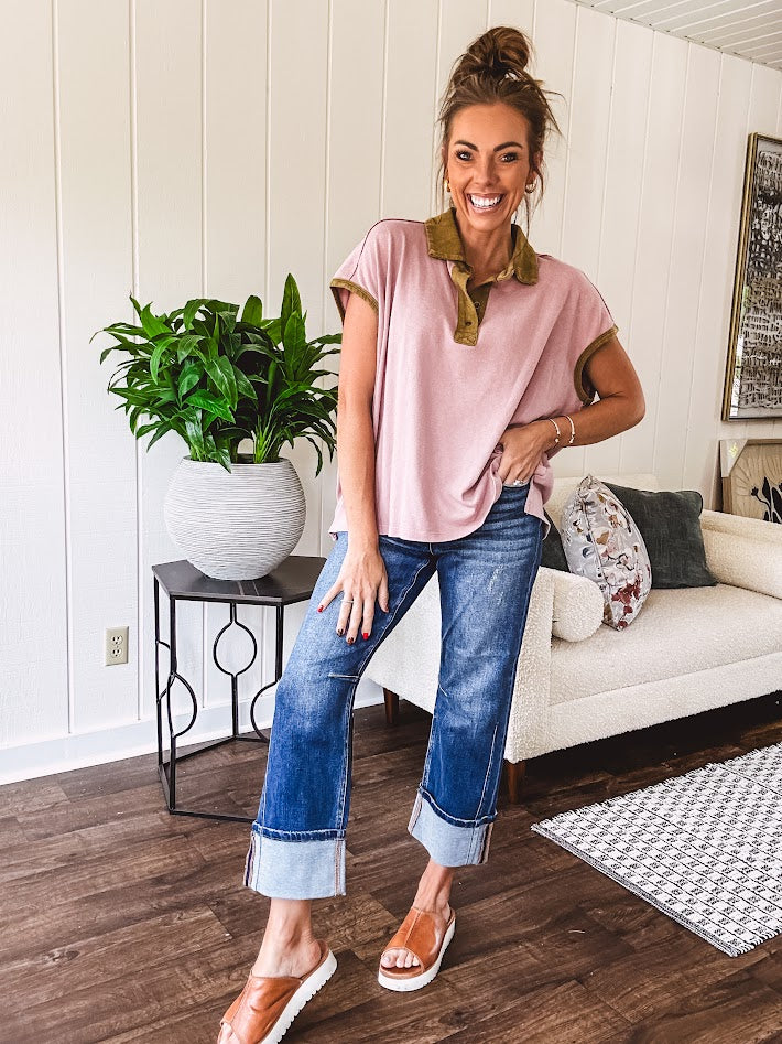 Soft, terry-like mauve top with cap sleeves, collar and split hem with contrasting olive at collar, three button front and cuffs.