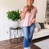Soft, terry-like mauve top with cap sleeves, collar and split hem with contrasting olive at collar, three button front and cuffs.