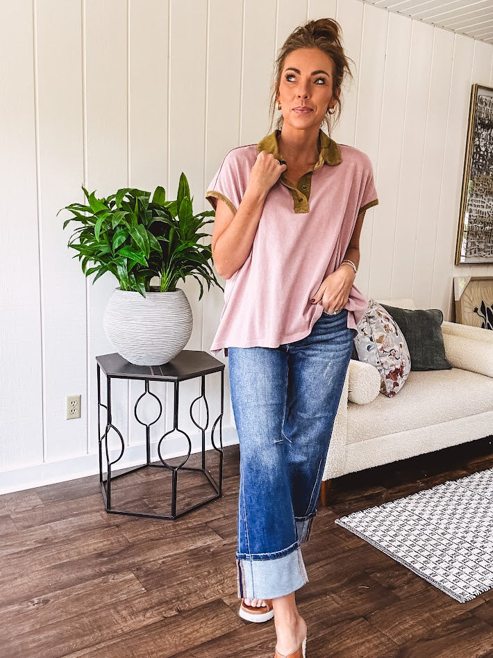 Soft, terry-like mauve top with cap sleeves, collar and split hem with contrasting olive at collar, three button front and cuffs.