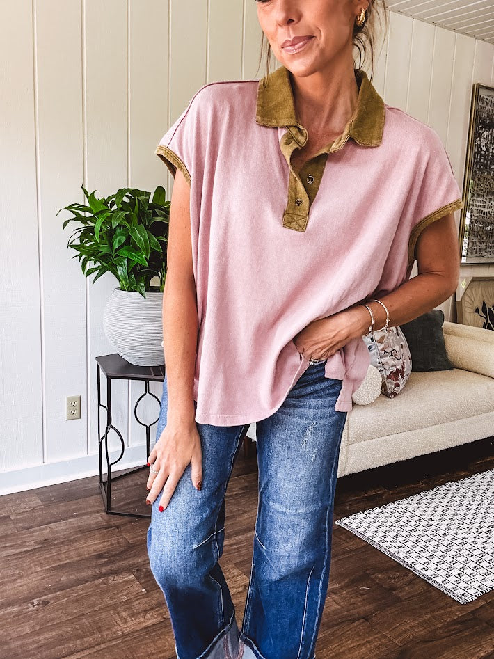 Soft, terry-like mauve top with cap sleeves, collar and split hem with contrasting olive at collar, three button front and cuffs.