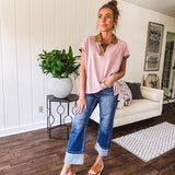 Soft, terry-like mauve top with cap sleeves, collar and split hem with contrasting olive at collar, three button front and cuffs.