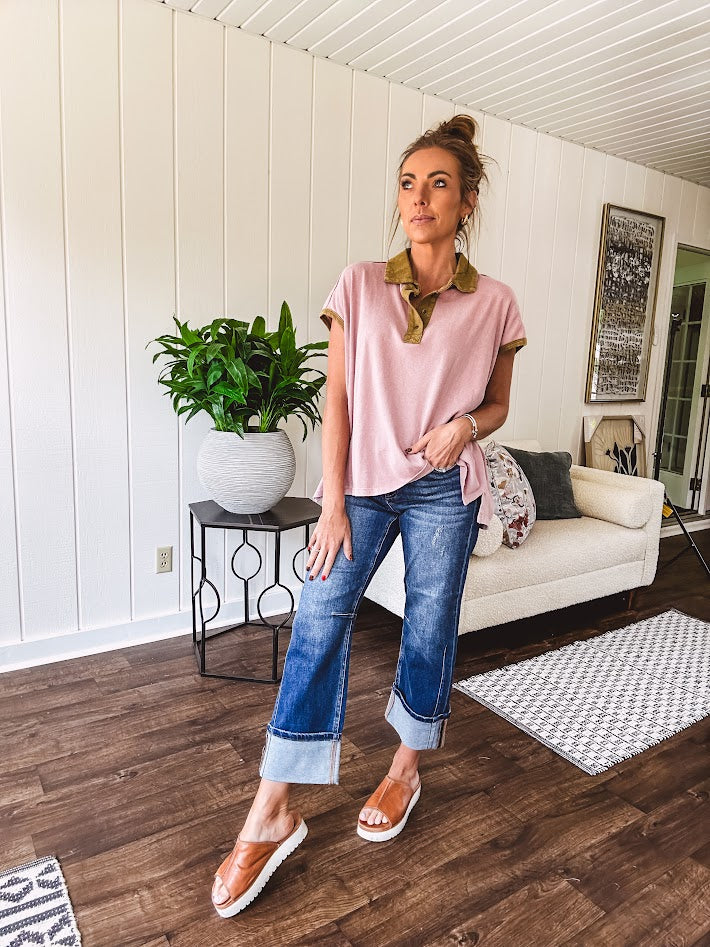 Soft, terry-like mauve top with cap sleeves, collar and split hem with contrasting olive at collar, three button front and cuffs.