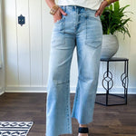 Light wash barrel jeans with extra large pockets and flared, raw hems.