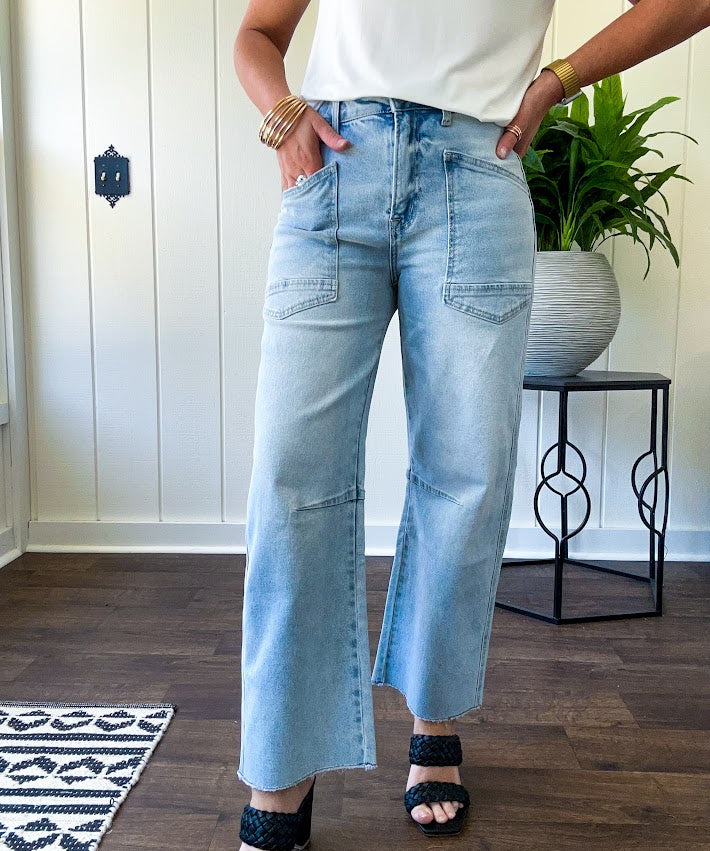 Light wash barrel jeans with extra large pockets and flared, raw hems.