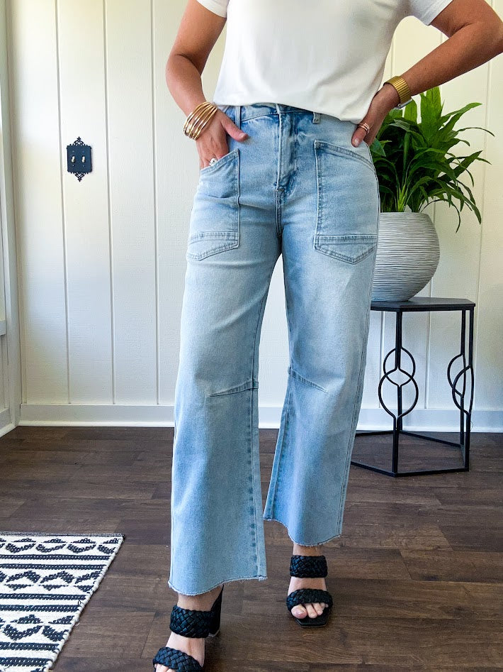Light wash barrel jeans with extra large pockets and flared, raw hems.