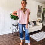 Soft, terry-like mauve top with cap sleeves, collar and split hem with contrasting olive at collar, three button front and cuffs.