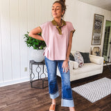 Soft, terry-like mauve top with cap sleeves, collar and split hem with contrasting olive at collar, three button front and cuffs.