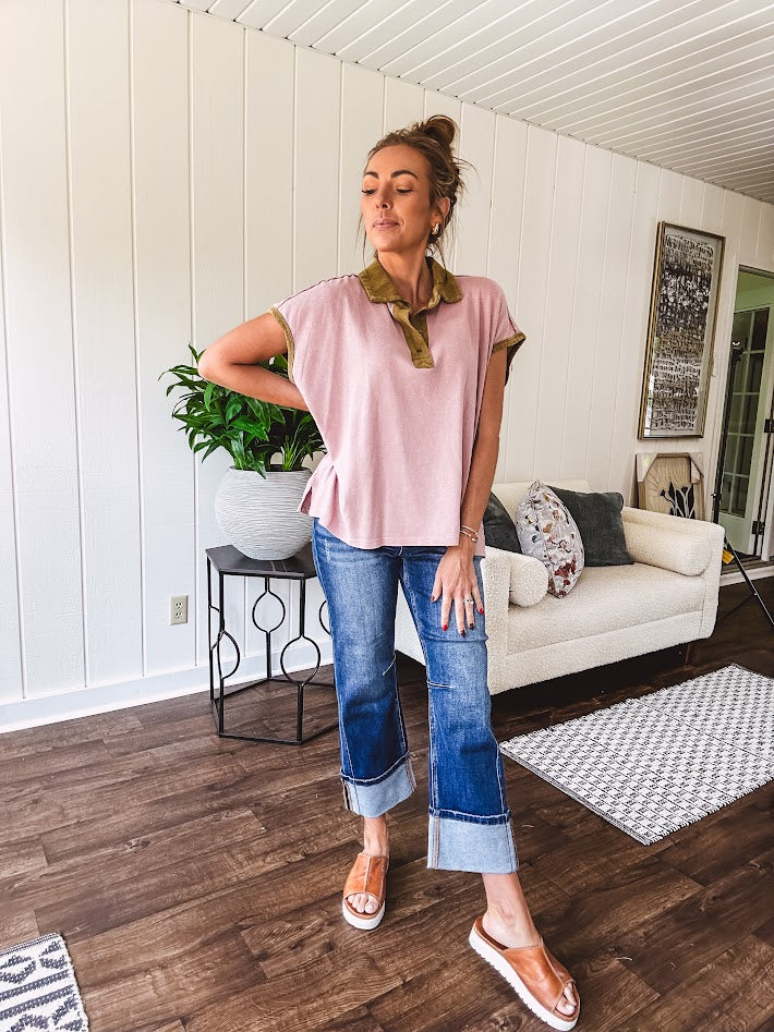 Soft, terry-like mauve top with cap sleeves, collar and split hem with contrasting olive at collar, three button front and cuffs.