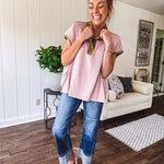 Soft, terry-like mauve top with cap sleeves, collar and split hem with contrasting olive at collar, three button front and cuffs.