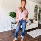 Soft, terry-like mauve top with cap sleeves, collar and split hem with contrasting olive at collar, three button front and cuffs.