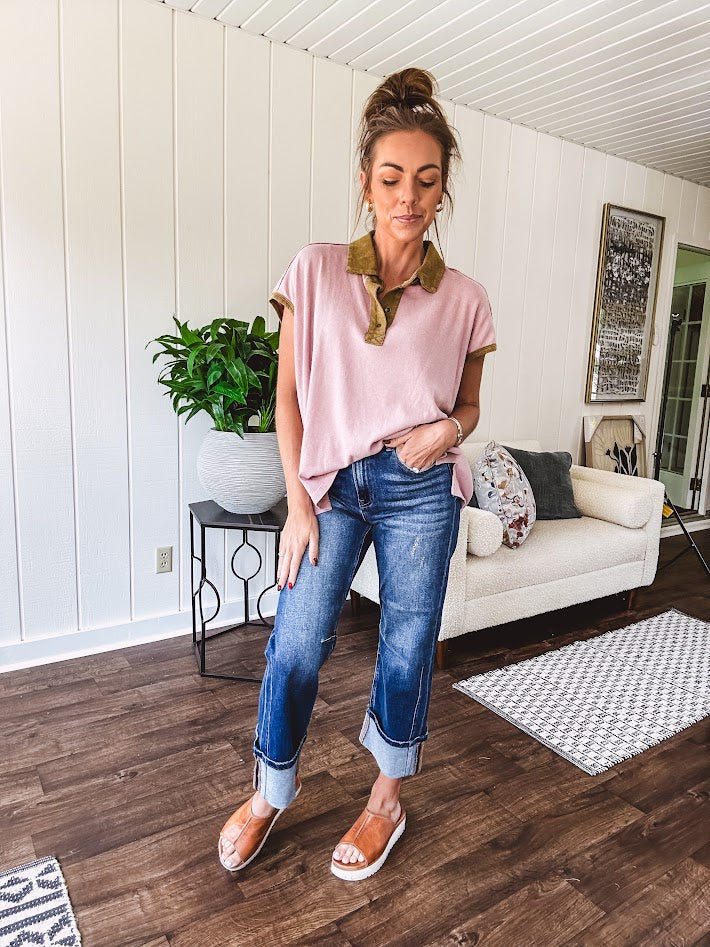 Soft, terry-like mauve top with cap sleeves, collar and split hem with contrasting olive at collar, three button front and cuffs.