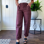 Brown barrel denim with high rise and cuffed hem at the ankle.