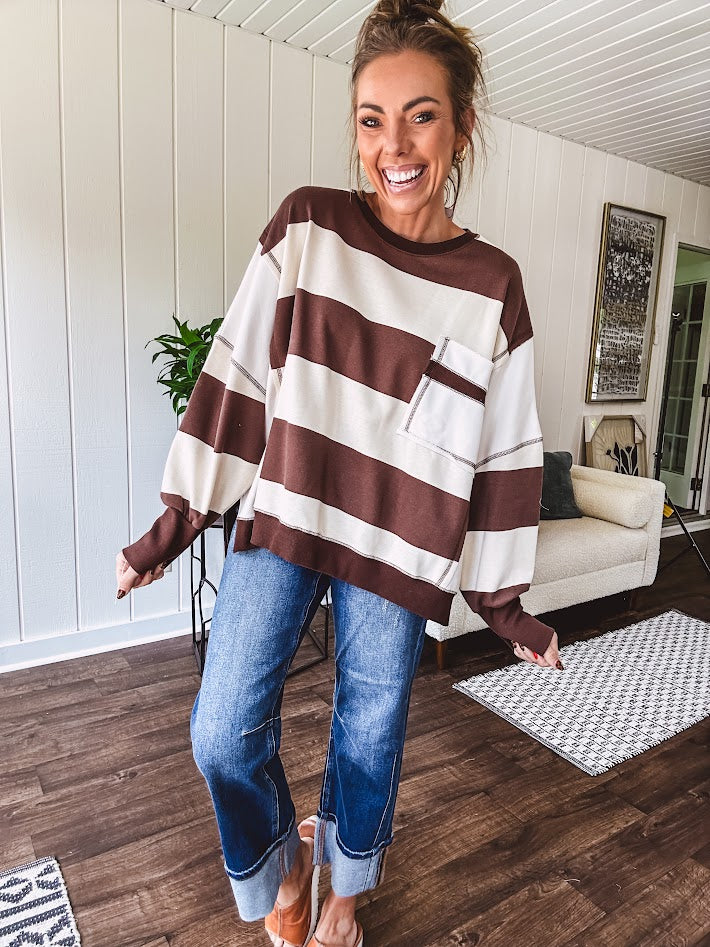 Oversized terry knit long sleeved pullover in brown and ivory large stripes, oversized front pocket, wide hem and cuffs and split hem.
