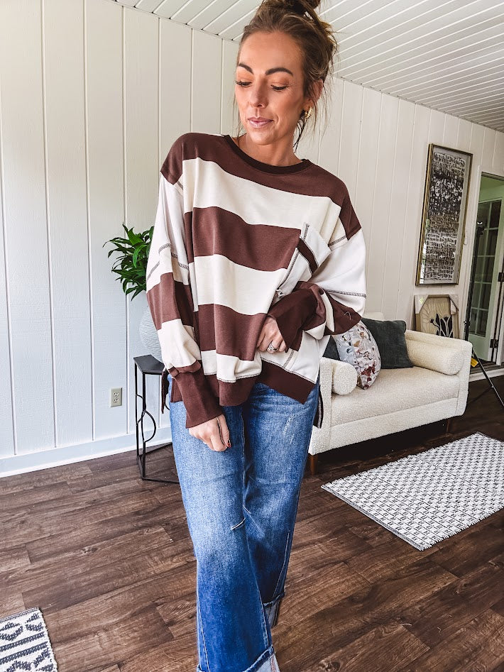 Oversized terry knit long sleeved pullover in brown and ivory large stripes, oversized front pocket, wide hem and cuffs and split hem.
