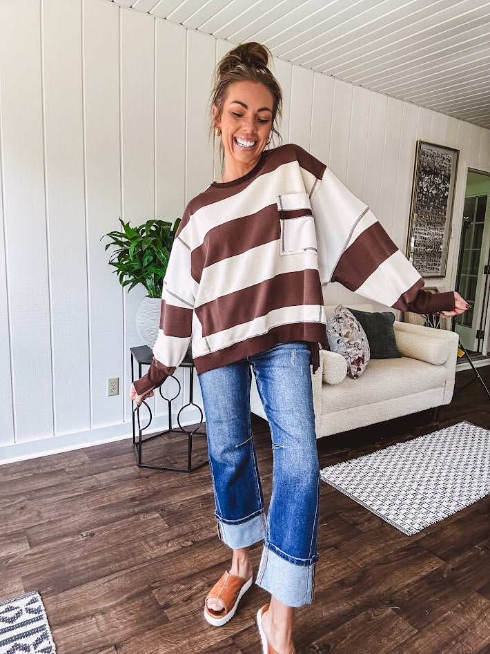 Oversized terry knit long sleeved pullover in brown and ivory large stripes, oversized front pocket, wide hem and cuffs and split hem.