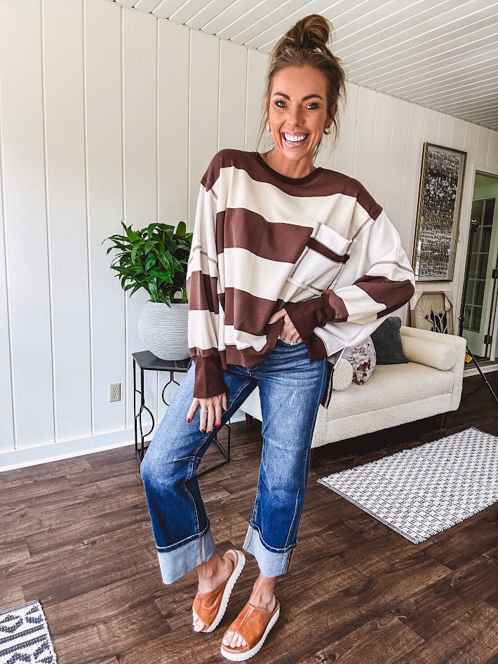Oversized terry knit long sleeved pullover in brown and ivory large stripes, oversized front pocket, wide hem and cuffs and split hem.