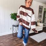 Oversized terry knit long sleeved pullover in brown and ivory large stripes, oversized front pocket, wide hem and cuffs and split hem.