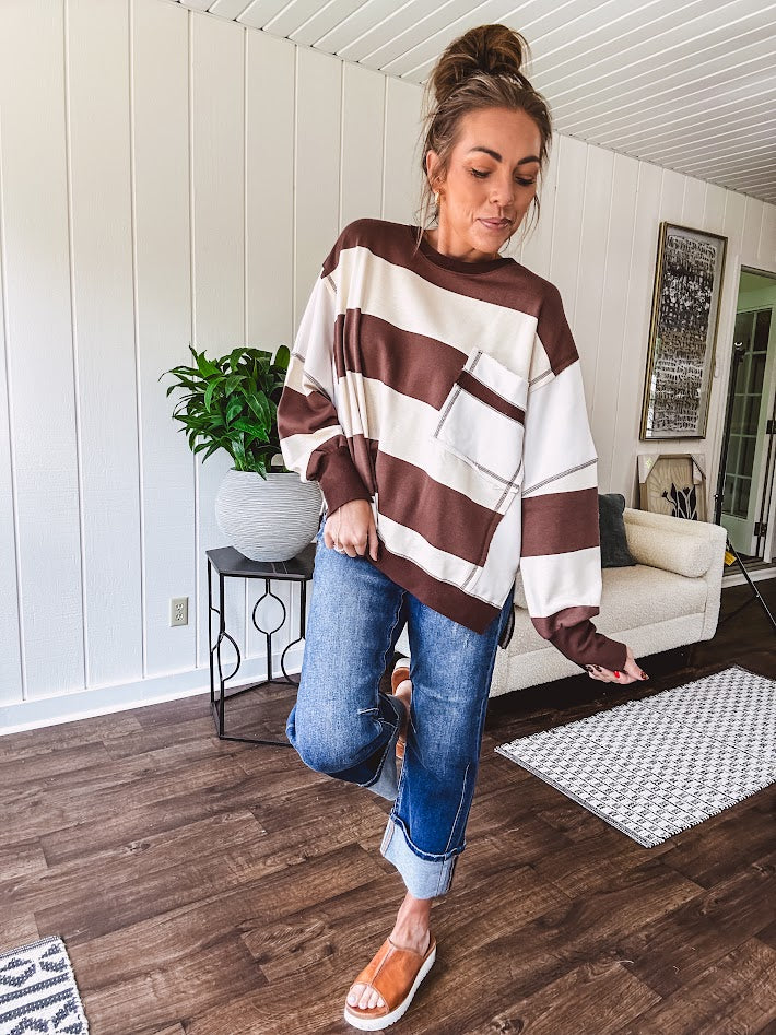 Oversized terry knit long sleeved pullover in brown and ivory large stripes, oversized front pocket, wide hem and cuffs and split hem.